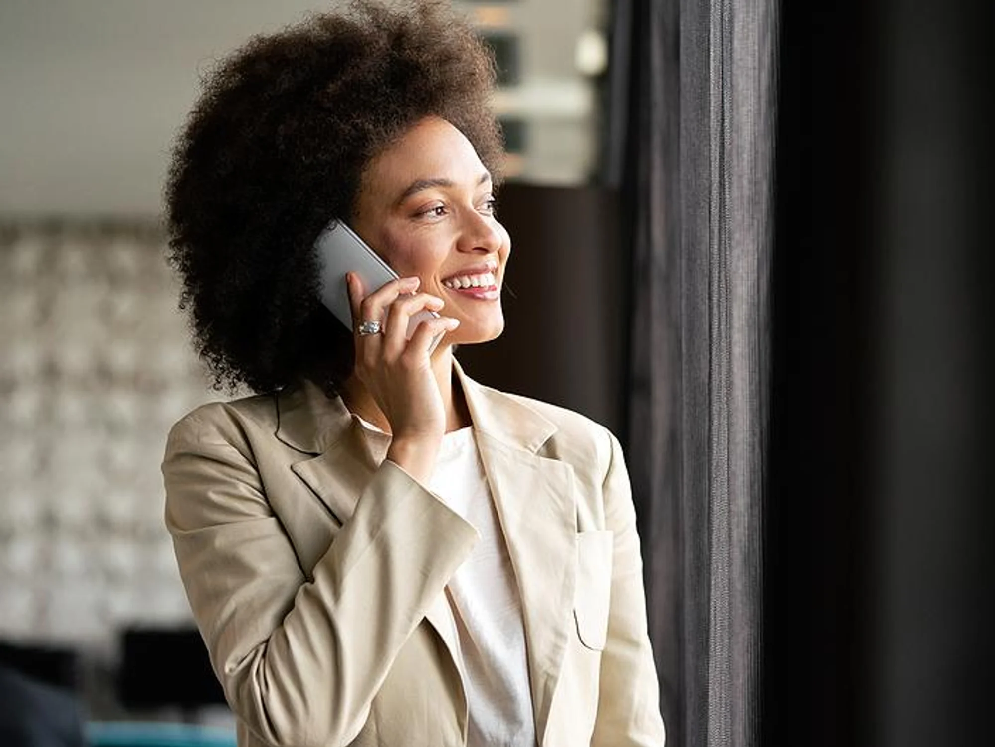 Woman smiles during a phone interview