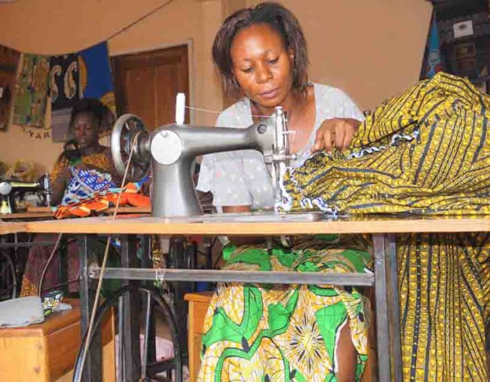 efiug Survivors of violence in Wakiso making local attires for sale.