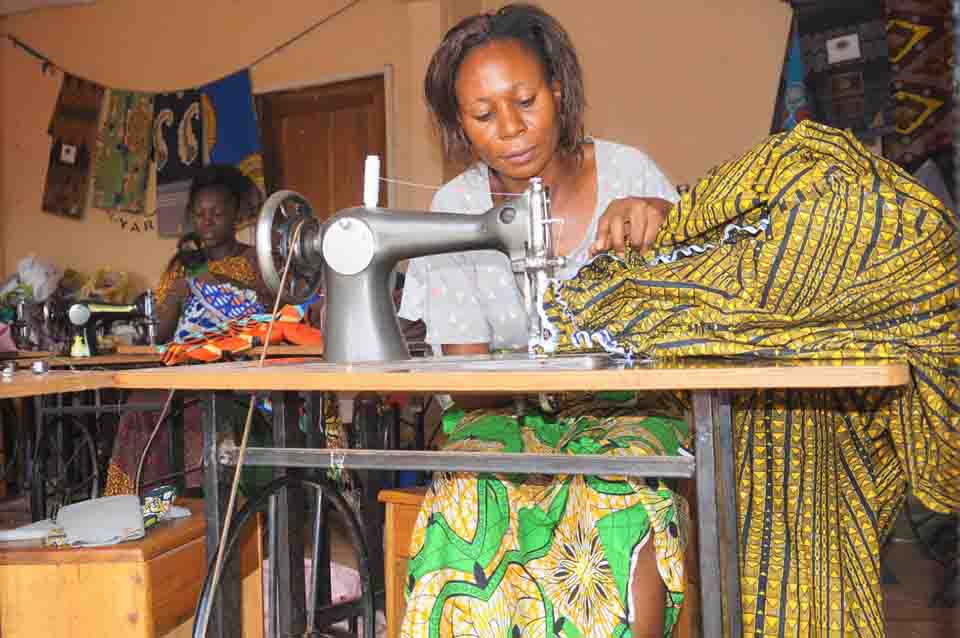 efiug Survivors of violence in Wakiso making local attires for sale.