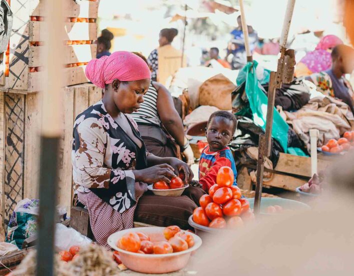 efiug beneficiary attends to her grocery store in Kasubi