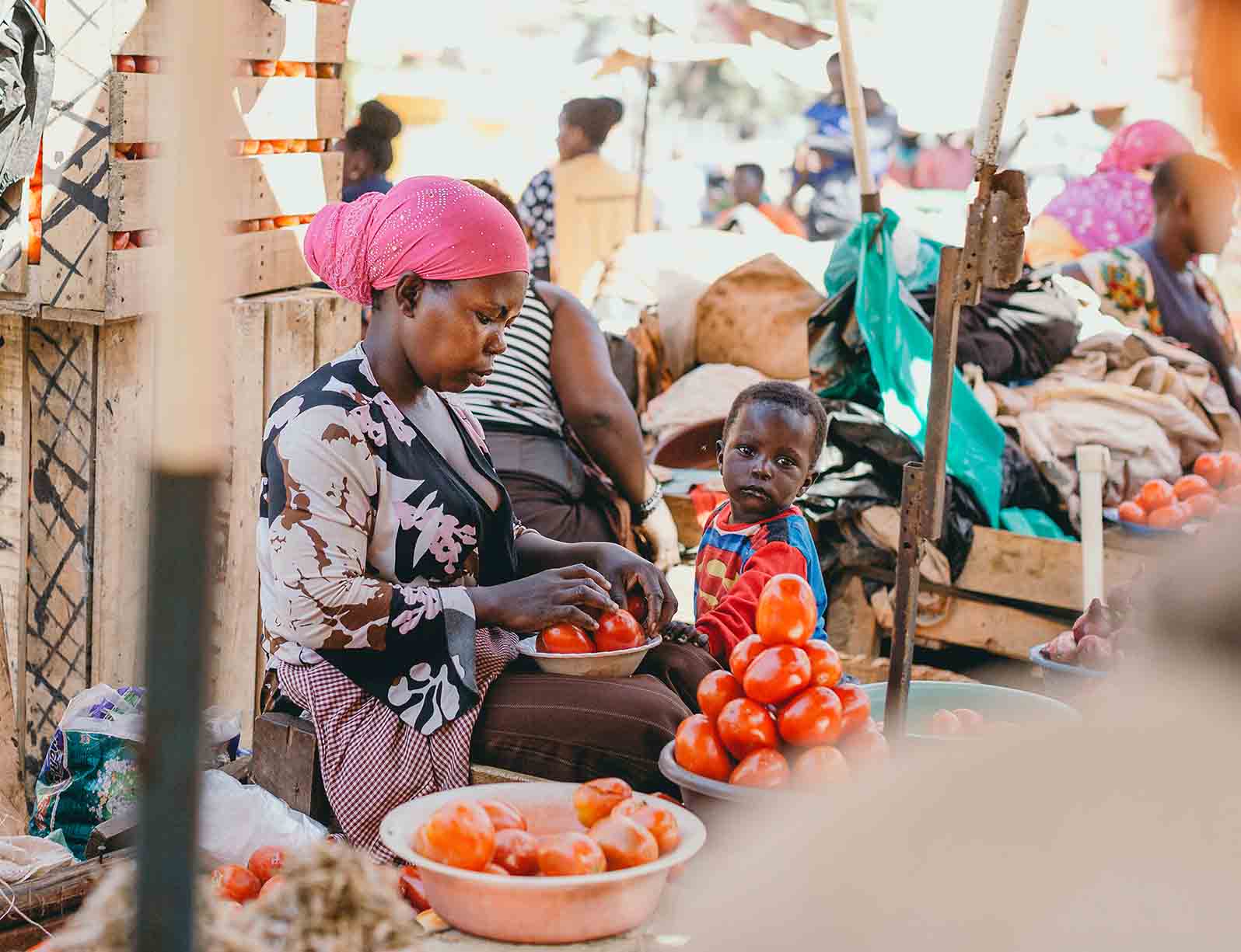 efiug beneficiary attends to her grocery store in Kasubi